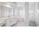 A white bathroom features a corner soaking tub, a separate shower, and white marble countertops at 13096 Linzia Ln, Spring Hill, FL 34609