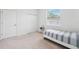 A bright bedroom features neutral carpet, a twin bed, a side table, and a closet at 13096 Linzia Ln, Spring Hill, FL 34609