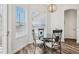 Well-lit breakfast nook featuring a glass-topped table with wrought iron chairs and multiple windows at 13096 Linzia Ln, Spring Hill, FL 34609