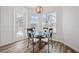 Cozy breakfast nook with an elegant glass table and wrought iron chairs near a bright window at 13096 Linzia Ln, Spring Hill, FL 34609
