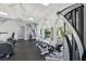 Well-equipped gym area with machines, free weights, and natural light streaming through arched windows at 13096 Linzia Ln, Spring Hill, FL 34609