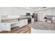 Modern kitchen with an island featuring stainless steel appliances, granite countertops, and wood floors at 13096 Linzia Ln, Spring Hill, FL 34609
