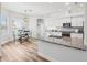 Open kitchen features a granite countertop, an eat-in breakfast nook, and stainless steel appliances at 13096 Linzia Ln, Spring Hill, FL 34609