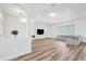 Bright living space with wood floors, tray ceiling, and view through to the living room with modern finishes at 13096 Linzia Ln, Spring Hill, FL 34609