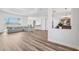 Spacious open-concept living area featuring wood floors and a seamless transition to the kitchen and living spaces at 13096 Linzia Ln, Spring Hill, FL 34609