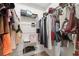 Organized walk-in closet with hanging clothes, handbags and shelving units at 13096 Linzia Ln, Spring Hill, FL 34609