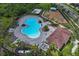Aerial view of a community pool with ample lounge seating and lush tropical landscaping at 13821 Kinsale St, Riverview, FL 33579