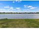 Scenic backyard view overlooking tranquil lake, lush grass, and community homes at 13821 Kinsale St, Riverview, FL 33579