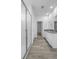 Modern bathroom with walk-in glass shower, wood-look tile flooring, and dual sink vanity at 13821 Kinsale St, Riverview, FL 33579