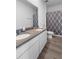 Bathroom featuring double sinks, granite countertop, and a shower/tub with stylish patterned curtain at 13821 Kinsale St, Riverview, FL 33579