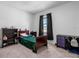 Cozy bedroom with carpet, complemented by black curtains and wooden furniture at 13821 Kinsale St, Riverview, FL 33579