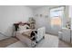 Bright bedroom featuring a large window, carpeted floor, and neutral color palette at 13821 Kinsale St, Riverview, FL 33579