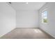 Bright, carpeted bedroom with ample natural light from a large window at 13821 Kinsale St, Riverview, FL 33579