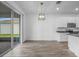 Open-concept kitchen and dining area with stainless steel appliances and sliding glass doors at 13821 Kinsale St, Riverview, FL 33579