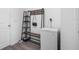 Neat entryway with a storage shelf, wall hooks, and a modern freezer at 13821 Kinsale St, Riverview, FL 33579