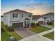 Two-story home with attached two-car garage, landscaped yard, and brick paver driveway at 13821 Kinsale St, Riverview, FL 33579