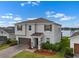 Beautiful two-story home with a well-manicured lawn, two-car garage, and view of the lake at 13821 Kinsale St, Riverview, FL 33579