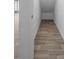 Hallway features modern wood-look tile flooring for an upgraded design at 13821 Kinsale St, Riverview, FL 33579
