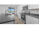 Contemporary kitchen offers stainless steel appliances and views of the lake at 13821 Kinsale St, Riverview, FL 33579