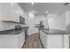 Modern kitchen with stainless steel appliances, white cabinets, and wood-look tile flooring at 13821 Kinsale St, Riverview, FL 33579