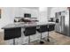 Bright kitchen with a large island, bar stools, modern stainless steel appliances, and plenty of storage at 13821 Kinsale St, Riverview, FL 33579