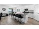 Bright kitchen features a center island with bar seating, white cabinetry, and stainless steel appliances at 13821 Kinsale St, Riverview, FL 33579