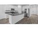 Modern kitchen featuring white cabinetry, stainless steel appliances, and a large center island with a sink at 13821 Kinsale St, Riverview, FL 33579