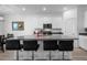 Modern kitchen with center island, bar stools, and stainless appliances, perfect for entertaining at 13821 Kinsale St, Riverview, FL 33579