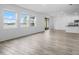 Bright living room with large windows offering a serene lake view and hardwood floors at 13821 Kinsale St, Riverview, FL 33579