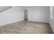 Open floor plan showcasing hardwood floors leading to a staircase in a well-lit area at 13821 Kinsale St, Riverview, FL 33579