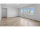 Spacious living room with wood-look tile flooring and serene lake views at 13821 Kinsale St, Riverview, FL 33579