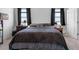 Comfortable main bedroom with side tables, lamps, and a large window overlooking the neighborhood at 13821 Kinsale St, Riverview, FL 33579