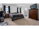 Spacious main bedroom with a large closet, ensuite bath, dark wood furnishings, and plush carpet at 13821 Kinsale St, Riverview, FL 33579