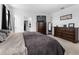 Bright and airy main bedroom with carpet floors, dresser, and an ensuite bathroom at 13821 Kinsale St, Riverview, FL 33579