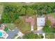 Aerial view of a residential property with a well-manicured yard and mature trees in a quiet neighborhood at 14006 79Th Ave, Seminole, FL 33776