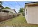 A partially-fenced backyard showing the side of the home at 14006 79Th Ave, Seminole, FL 33776