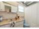 Charming bathroom with nautical-themed wallpaper, blue fixtures, and ample countertop space at 14006 79Th Ave, Seminole, FL 33776