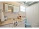 Charming bathroom with blue accents, including a sink, toilet, and nautical themed wallpaper at 14006 79Th Ave, Seminole, FL 33776