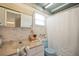 Quaint bathroom featuring blue fixtures, sink, and a shower with a classic design and a nautical wallpaper at 14006 79Th Ave, Seminole, FL 33776