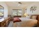Inviting bedroom featuring wood furniture, large window with natural light, and neutral carpet at 14006 79Th Ave, Seminole, FL 33776
