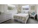 Cozy bedroom with wicker furniture and two windows for natural light at 14006 79Th Ave, Seminole, FL 33776