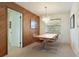 Dining room featuring a modern chandelier, wooden table, and comfortable seating, perfect for Gathering meals at 14006 79Th Ave, Seminole, FL 33776
