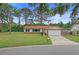 Charming single-story home with a well-maintained lawn, brick accents, and attached garage at 14006 79Th Ave, Seminole, FL 33776