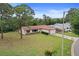 Charming single-story home with a well-maintained lawn, brick accents, and attached garage at 14006 79Th Ave, Seminole, FL 33776