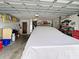Spacious garage with tools, a workbench, and covered vehicle at 14006 79Th Ave, Seminole, FL 33776