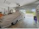 Open garage featuring covered car and garage door open to front yard at 14006 79Th Ave, Seminole, FL 33776