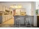 Open concept kitchen and bar with bright lighting, seating for two and vintage cabinets at 14006 79Th Ave, Seminole, FL 33776
