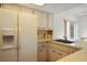 Updated kitchen with bright countertops, vintage white refrigerator and matching cabinets at 14006 79Th Ave, Seminole, FL 33776