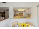 Kitchen features yellow counters, tile ceiling, and open view to dining area at 14006 79Th Ave, Seminole, FL 33776