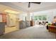 Bright, open-concept living room with counter bar, modern carpet, and large windows with lots of natural light at 14006 79Th Ave, Seminole, FL 33776